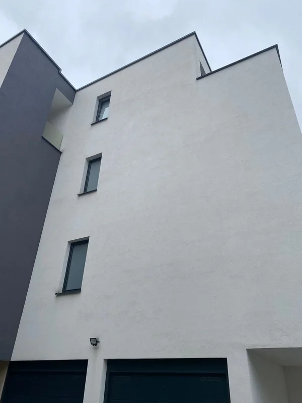 The same facade after drone washing, clean and even in colour